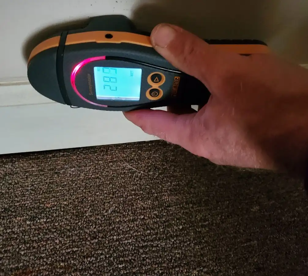 Moisture detection at baseboard during Storm Damage Restoration in Baker